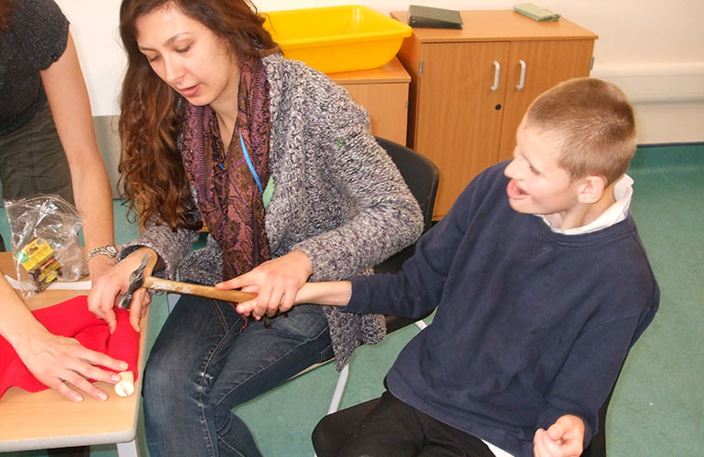 Photograph of using a hammer in a Build A Book session